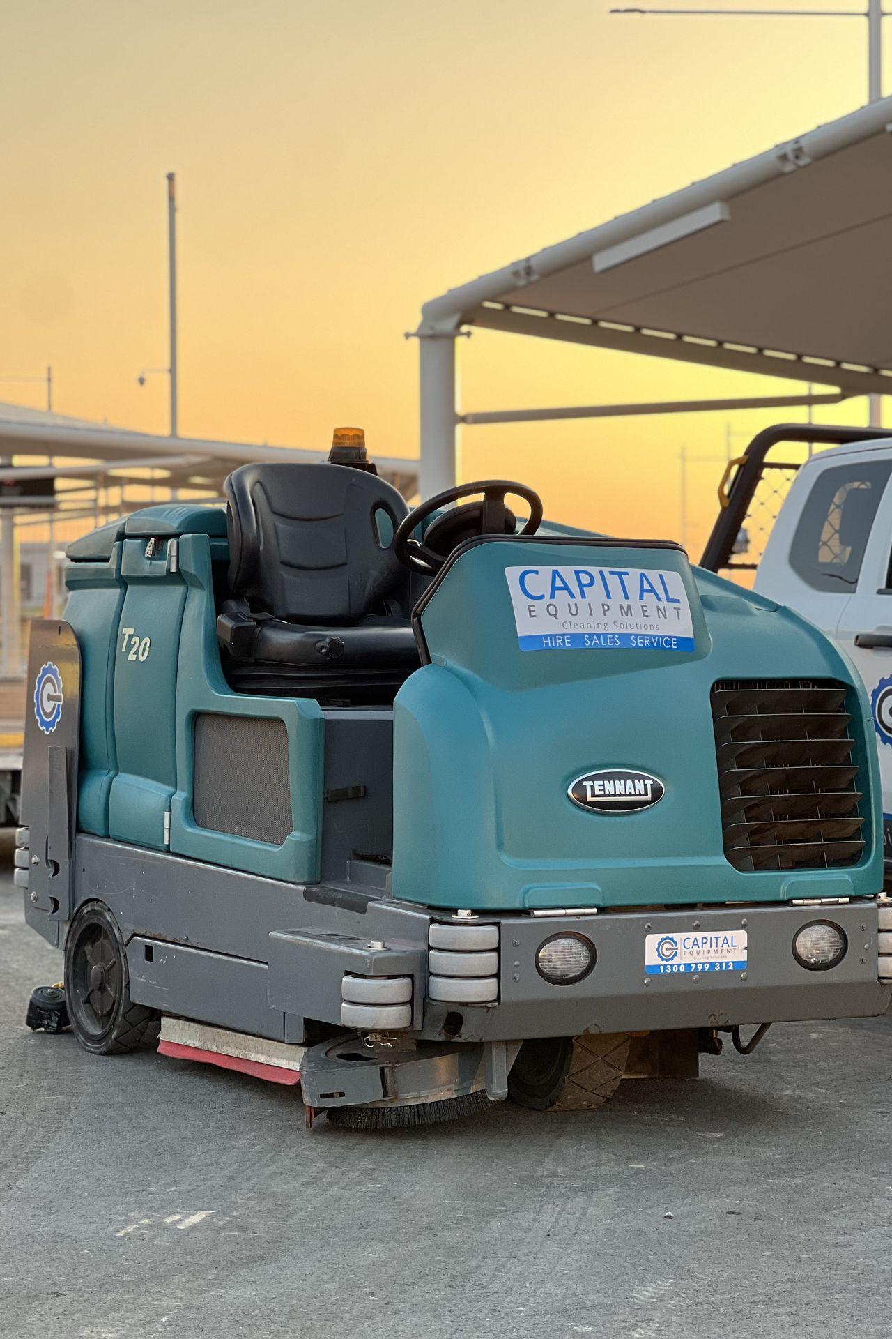 Aviation cleaning machine operating on airport apron near terminal area.