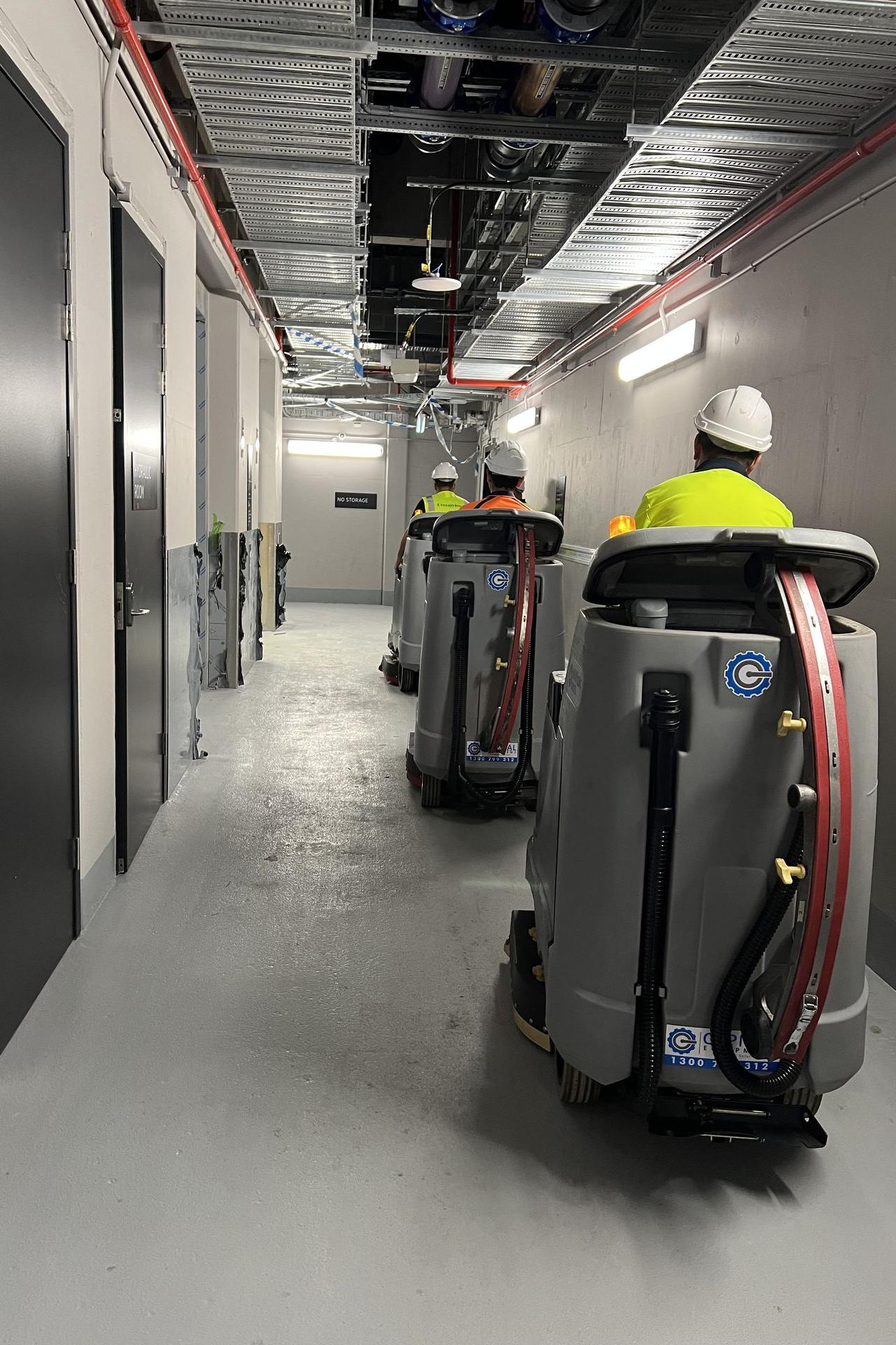 Industrial cleaning machine maintaining cleanliness in an airport service corridor.
